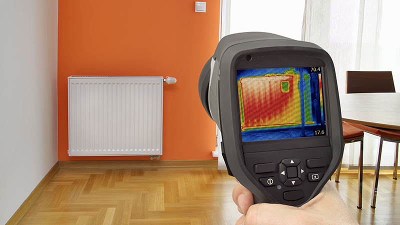 Thermal imaging camera being used while preforming inspection services to detect heat loss